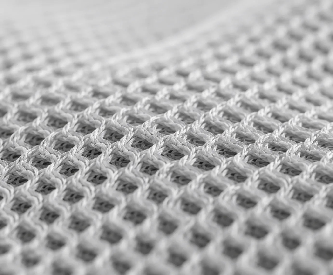 Soft white open-knit structure illustrating breathable baby-contact material construction