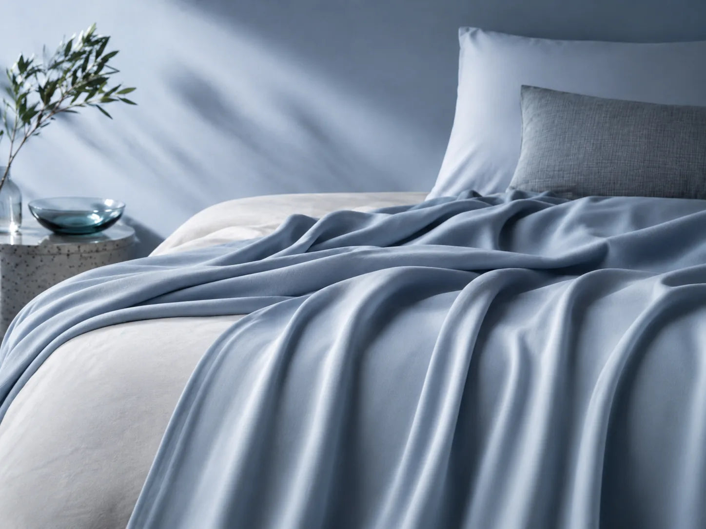 Blue cooling blanket in a calm bedroom setting.
