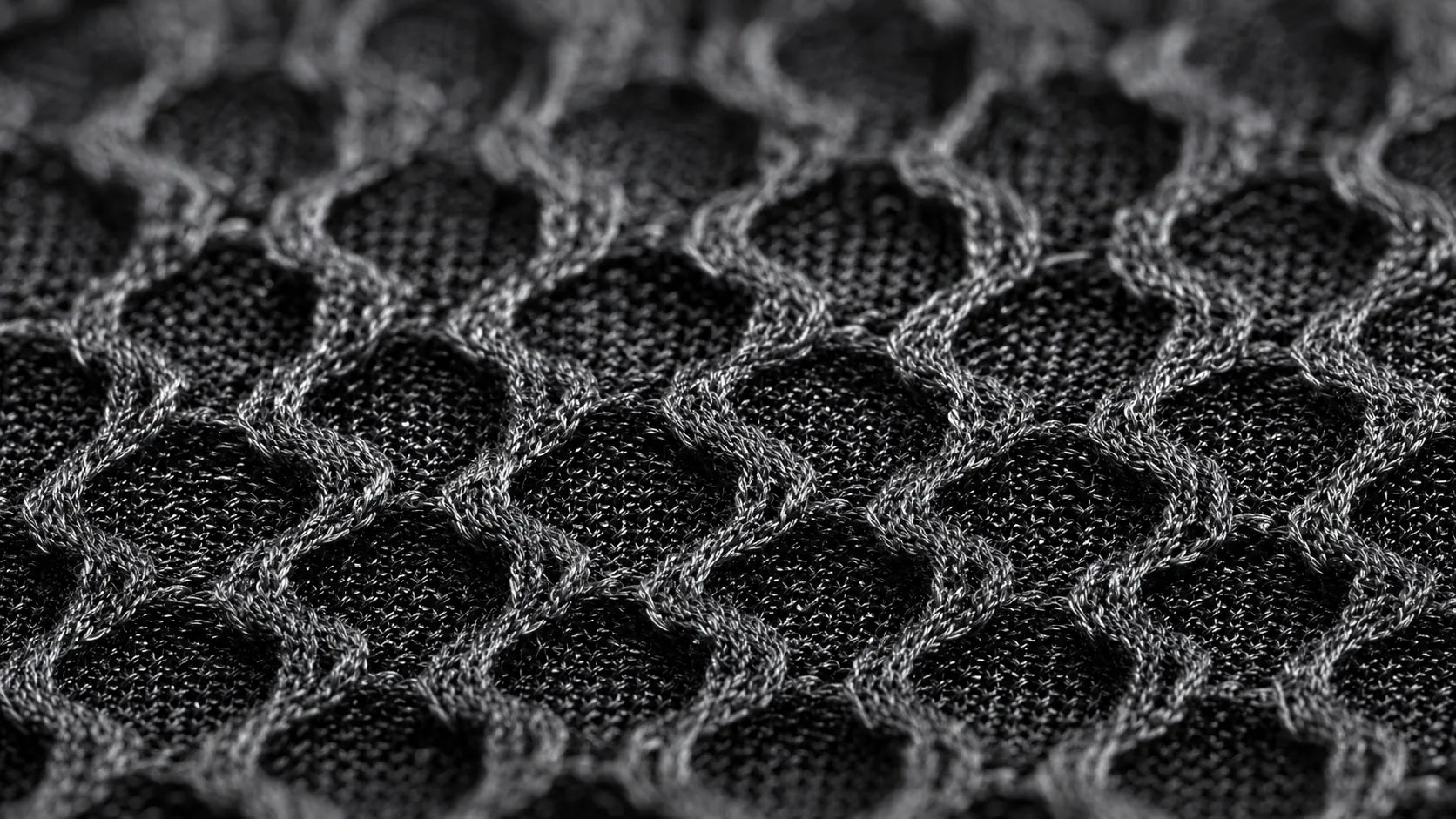 Dense black honeycomb knit structure supporting airflow in close-to-skin apparel