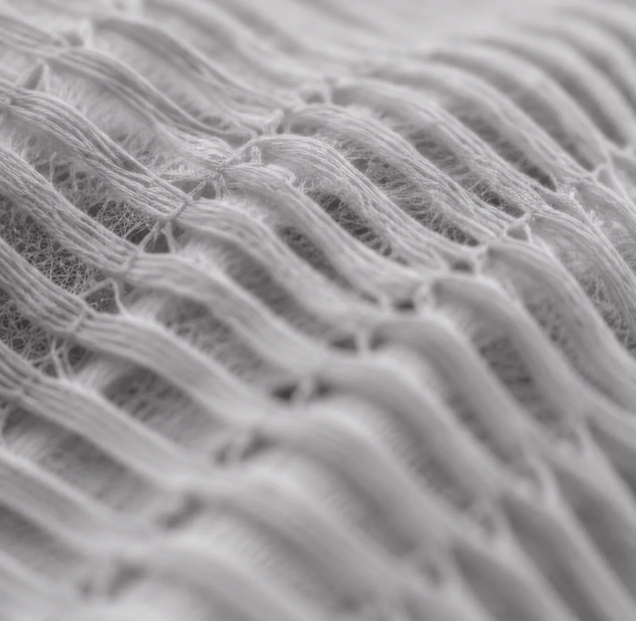 Soft layered white textile structure illustrating material and moisture movement