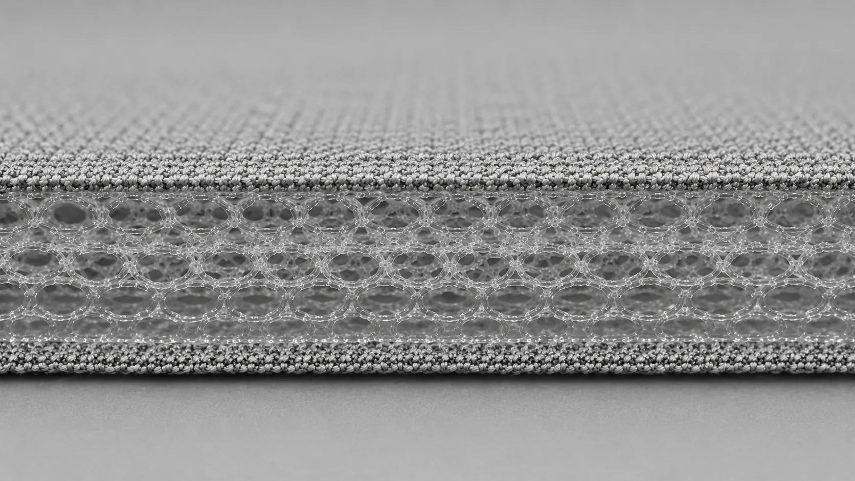 Layered light textile and open-cell cushioning structure for pet-care applications
